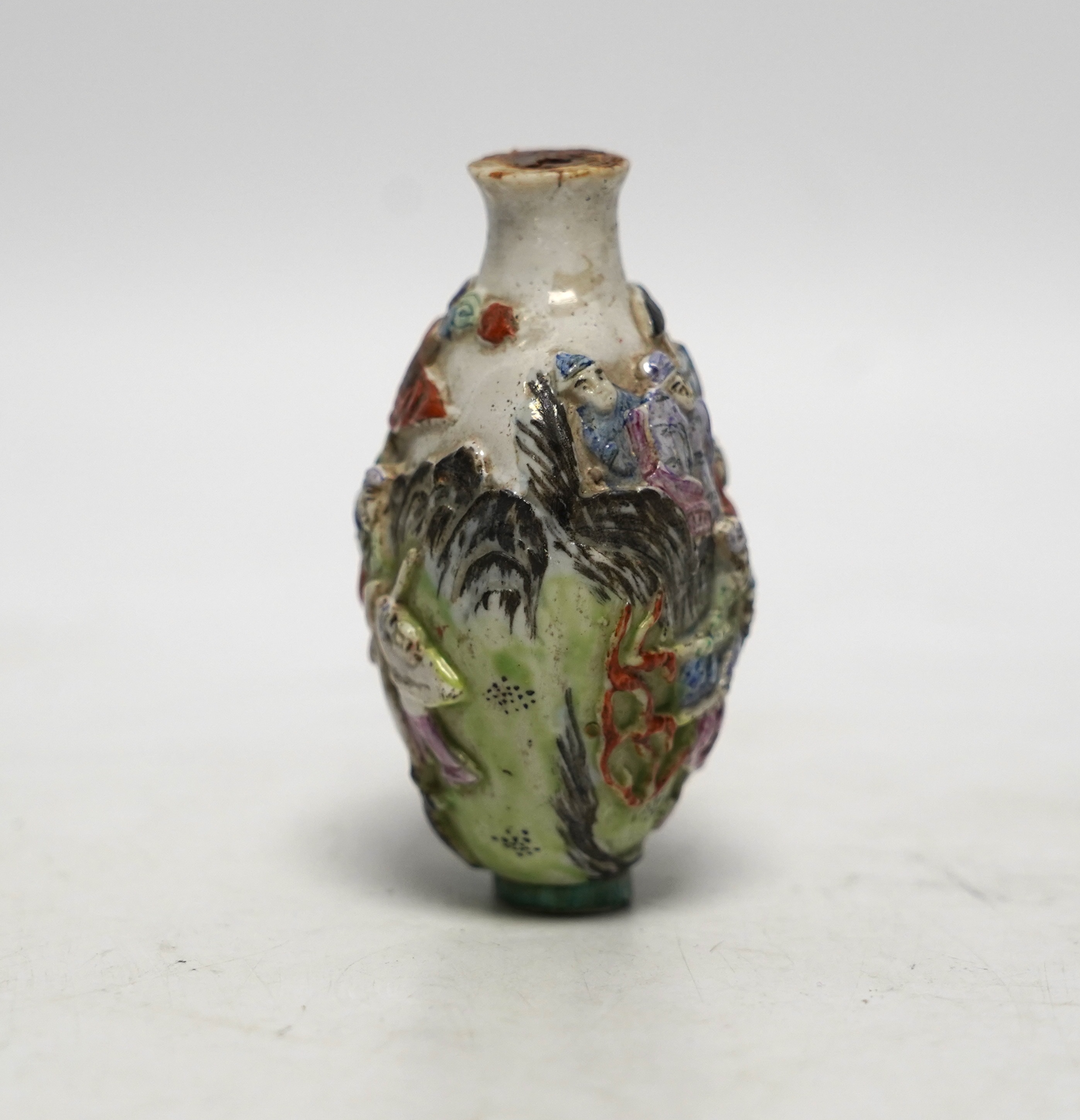 A Chinese moulded in enamelled porcelain ‘figures riding mythical beasts’ snuff bottle, Qianlong mark, 19th century, 8.5cm high